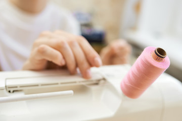 Tailor working on treading the sewing machine