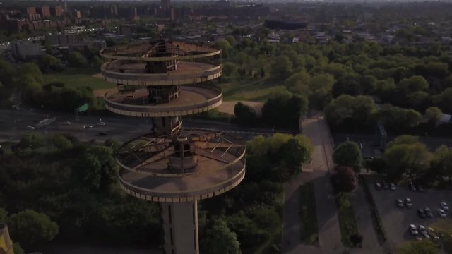 descending & tilting up next to NY Pavilion towers with Manhattan in background