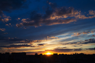 Beautiful sunrise over big city with amazing clouds