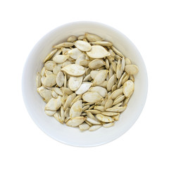Pumpkin seeds bowl isolated on white