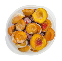 Frozen peaches apricot strawberries in a bowl isolated on white background
