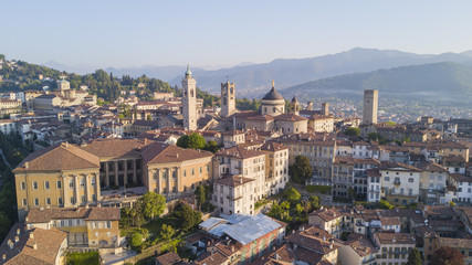 Fototapeta na wymiar Drone aerial view of Bergamo - Old city. One of the beautiful city in Italy. Landscape on the city center, its historical buildings and towers during a wonderful blu day