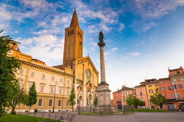 Piacenza, medieval town, Italy. Piazza Duomo in the city center with the cathedral of Santa Maria Assunta and Santa Giustina, warm light at sunset. Emilia Romagna - obrazy, fototapety, plakaty