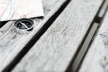 Compass and map on a beautiful wooden surface