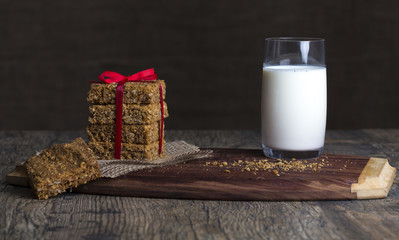 Stack of oatmeal crunchy cookies and milk in background