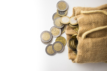 A lot of money - jute bag full of euro coins isolated on white background