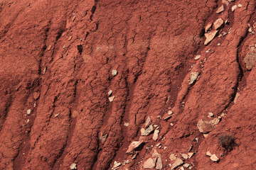 Eroded clay slope of the mountain with limestone rocks