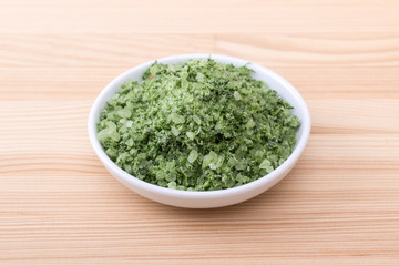 herbal salt from wild garlic / Porcelain bowl with green herbal salt of wild garlic 