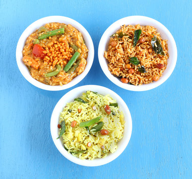 South Indian traditional and popular vegetarian rice dishes bisi bele bath, puliyogare, and lemon rice.