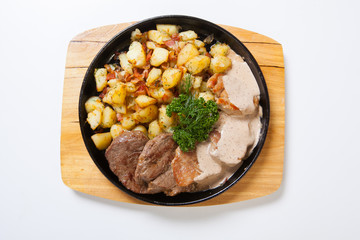 different kind of meat with potatoes on a grill pan