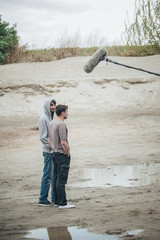 Behind the scene. Two actors in front of boom microphone © guruXOX