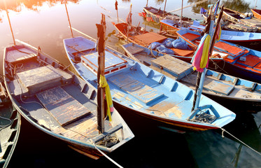 Fototapeta na wymiar Row of small wooden fishing boats.