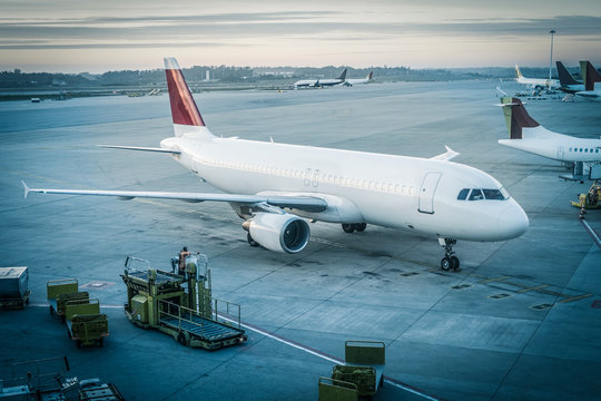 Passenger airplane is waiting for departure in airport, symbol traffic transport aviation