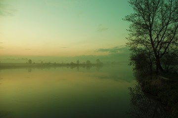 Fototapeta na wymiar Foggy River Bank Scenery