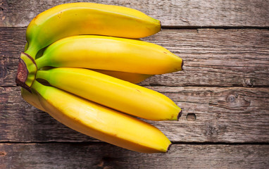 Bundle of bananas on vintage wooden background, selective focus