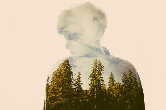 Double exposure of woman and trees