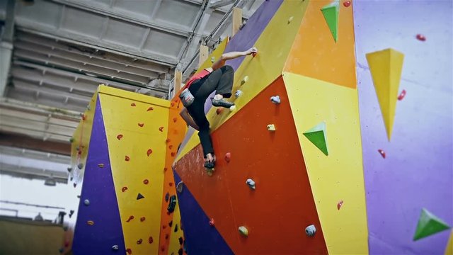 Climber Man On Artificial Climbing Wall In Bouldering Gym Without Insurance.