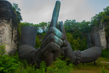 Garuda Wisnu Kencana Cultural Park. Huge hands of a statue of Vishnu. Bali. Indonesia.