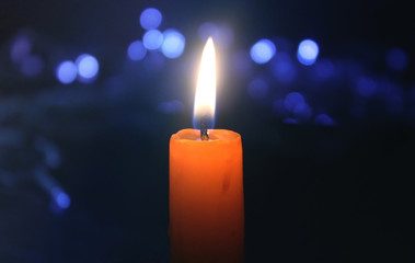 Burning candle with christmas lights 