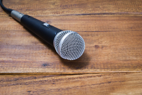 dynamic microphone on wooden floor, music background