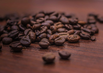 Black coffee beans on a brown tree