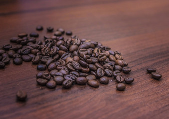Black coffee beans on a brown tree
