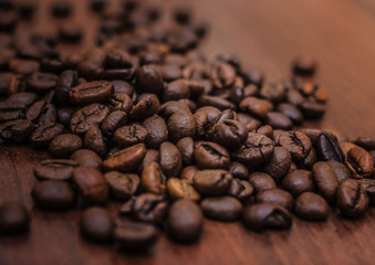 Black coffee beans on a brown tree