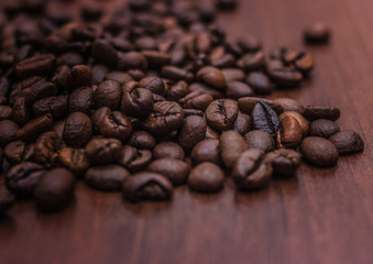 Black coffee beans on a brown tree