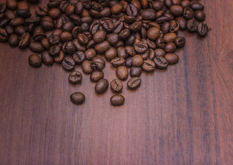 Black coffee beans on a brown tree