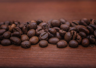 Black coffee beans on a brown tree