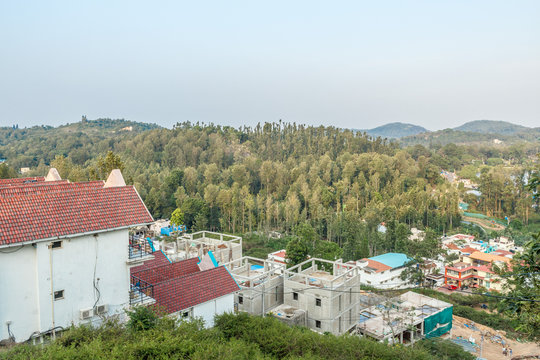 Multi colored row houses on top of a hill station with mountain in the background,Salem, Yercaud, tamilnadu, India, April 29 2017