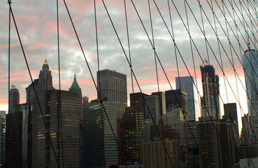 Manhattan cityscape at sunset from brooklyn bridge