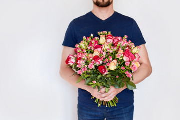 a man with red roses in the hands. valentine day love beautiful