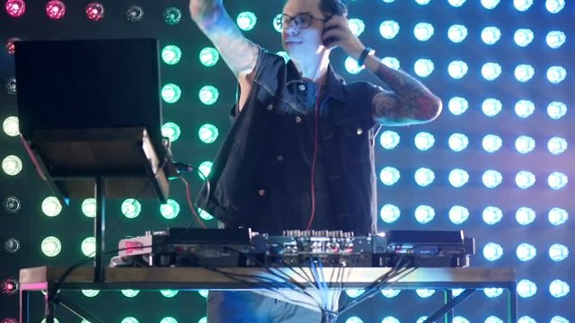 DJ clapping and moving to the music. HD.