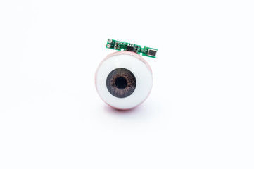 Anatomical model of human eye or eyeball with digital artificial microchip on white background....