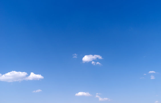 A few clouds in a bright blue sky