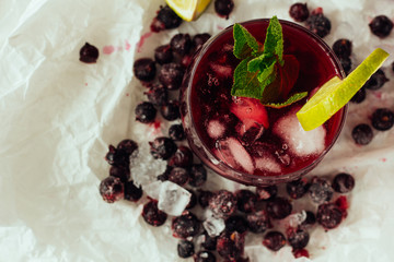 Berry cocktails with mint and lime in glass top view