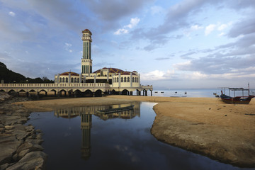 Fototapeta premium Reflection of minaret from a calm pool of water. 