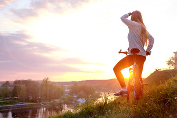 Girl riding bike in sunset