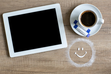 Tablet and mug of coffee.