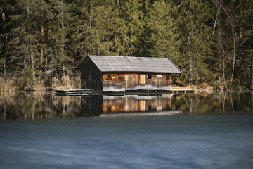 Fototapeta na wymiar Hut At Frozen Lake, Austria