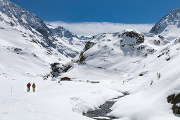 Fototapeta na wymiar Hikers In Winter Valley, Austria