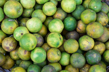 Fresh mandarin oranges on an organic food market of tropical Bali island, Indonesia. Mandarin background.