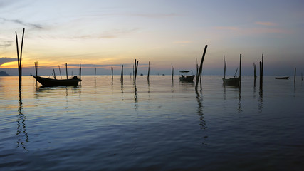 Fototapeta premium View in Time of sunrise on a beach of a fishing village