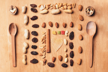 Spoons among food ingredients on wood