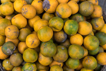Fresh mandarin oranges on an organic food market of tropical Bali island, Indonesia. Mandarin background.
