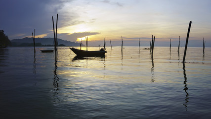 View in Time of sunrise on a beach of a fishing village