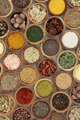 Culinary spice and herb seasoning in wooden bowls, high in vitamins and minerals.