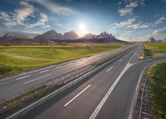 Empty freeway through vastness at idyllic sunrise