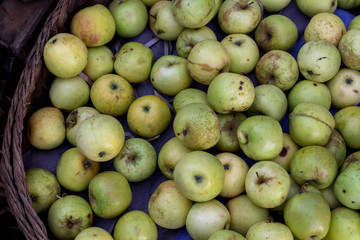 Green apples on the organic traditional food market of tropical Bali island, Indonesia. Sukawati market. Apples background.